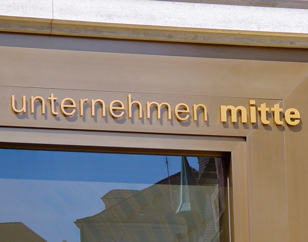 logo-unternehmen-mitte-beschriftung-scanu